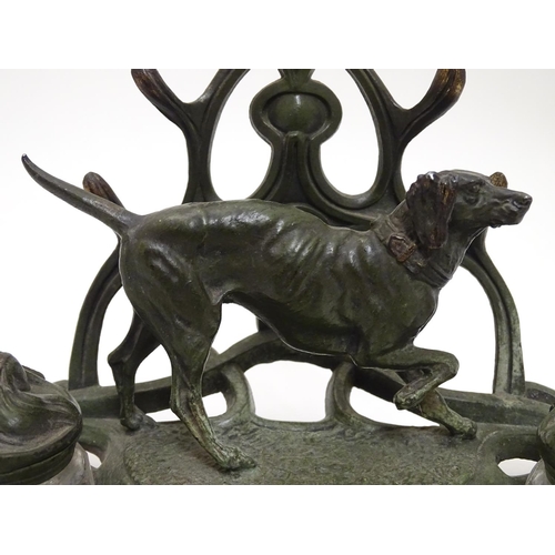 147 - An early - mid 20thC spelter Standish with dog and stylised Art Nouveau foliate decoration with twin... 