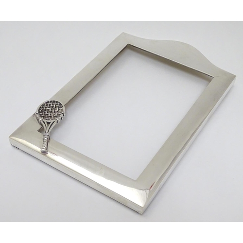 151 - A silver photograph frame surround with tennis racket motif. Marked Sterling .925 The whole 7 3/4'' ... 