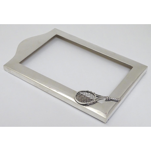 151 - A silver photograph frame surround with tennis racket motif. Marked Sterling .925 The whole 7 3/4'' ... 