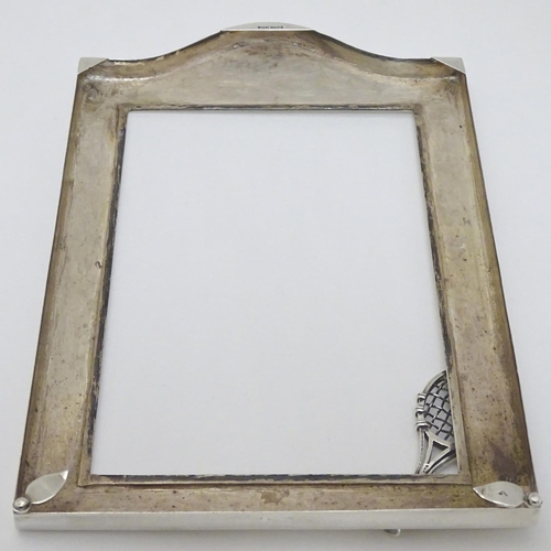 151 - A silver photograph frame surround with tennis racket motif. Marked Sterling .925 The whole 7 3/4'' ... 