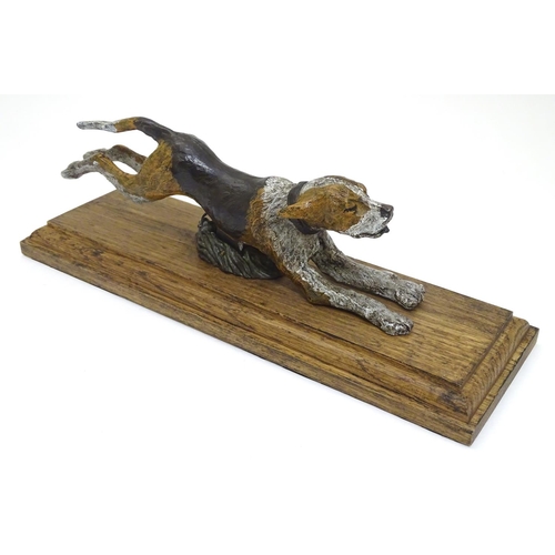 166 - A desk top letter clip formed as a cold painted bronze hound / dog mounted on an stained oak base. 2... 