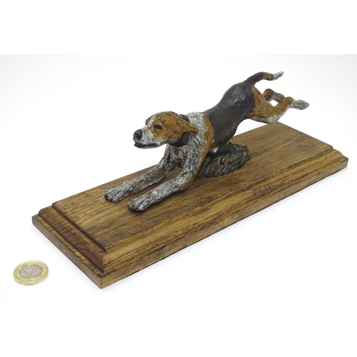 166 - A desk top letter clip formed as a cold painted bronze hound / dog mounted on an stained oak base. 2... 