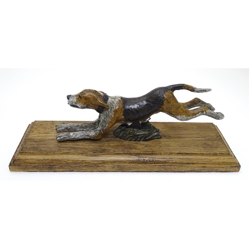 166 - A desk top letter clip formed as a cold painted bronze hound / dog mounted on an stained oak base. 2... 