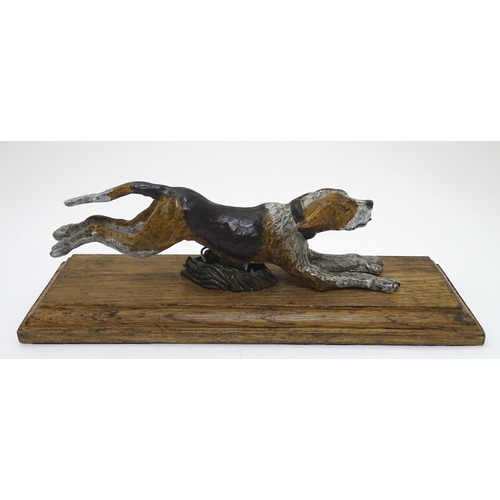 166 - A desk top letter clip formed as a cold painted bronze hound / dog mounted on an stained oak base. 2... 