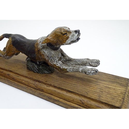 166 - A desk top letter clip formed as a cold painted bronze hound / dog mounted on an stained oak base. 2... 