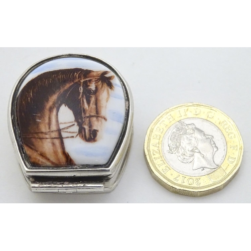 170 - A silver pill box formed as a horseshoe with horse head decoration to top. 1 1/4'' long