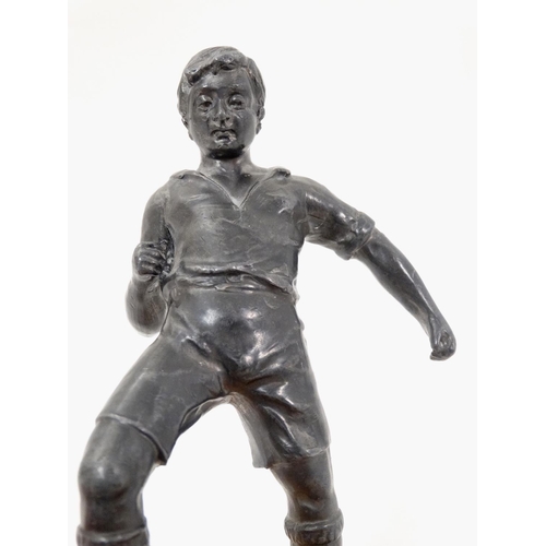 186 - A mid 20thC cast metal model of a footballer? Probably Russian. On wooden base. The whole 6 3/4'' hi... 