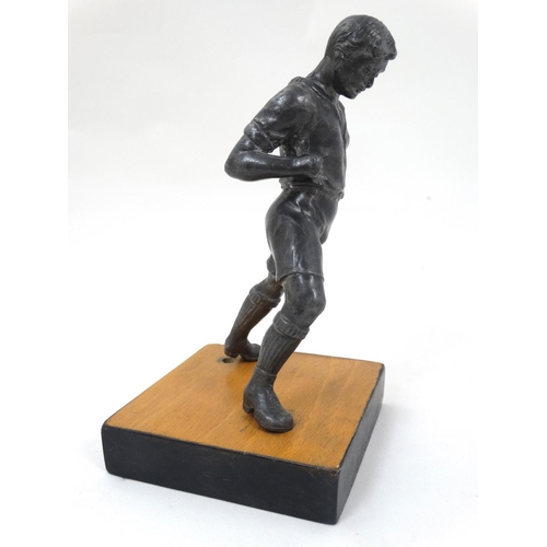 186 - A mid 20thC cast metal model of a footballer? Probably Russian. On wooden base. The whole 6 3/4'' hi... 