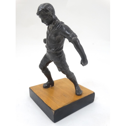 186 - A mid 20thC cast metal model of a footballer? Probably Russian. On wooden base. The whole 6 3/4'' hi... 