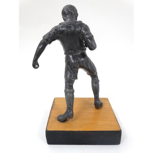 186 - A mid 20thC cast metal model of a footballer? Probably Russian. On wooden base. The whole 6 3/4'' hi... 