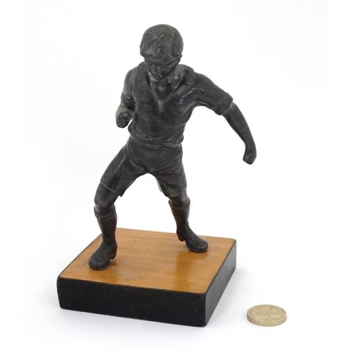 186 - A mid 20thC cast metal model of a footballer? Probably Russian. On wooden base. The whole 6 3/4'' hi... 