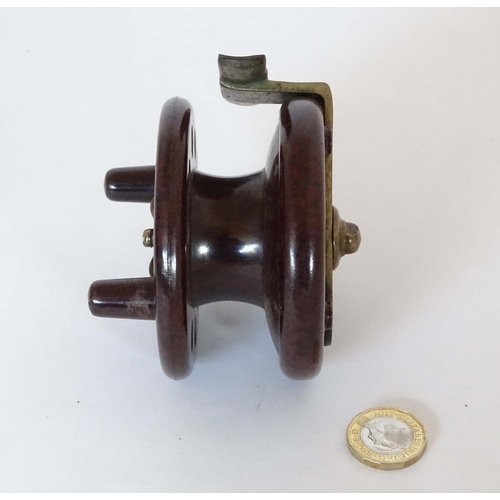 230 - Fishing :A Modern Arms Co Bakelite Trotting Reel with two handles and 8 holes, free run and clicker ... 