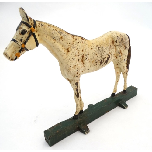 327 - A cast iron doorstop formed as a horse with polychrome decoration. 10'' high