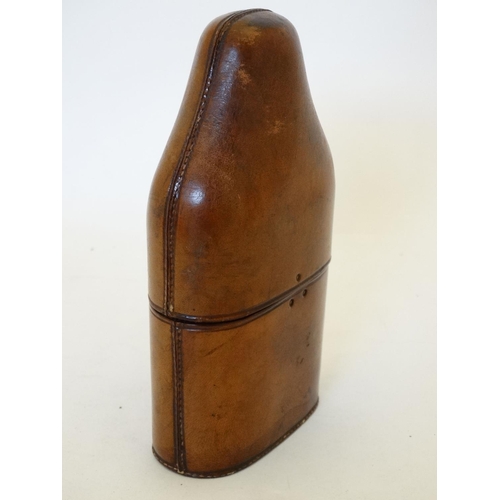 343 - Field Sports : An early 20thC glass flask with silver plate tot cup to top within a brown leather ca... 