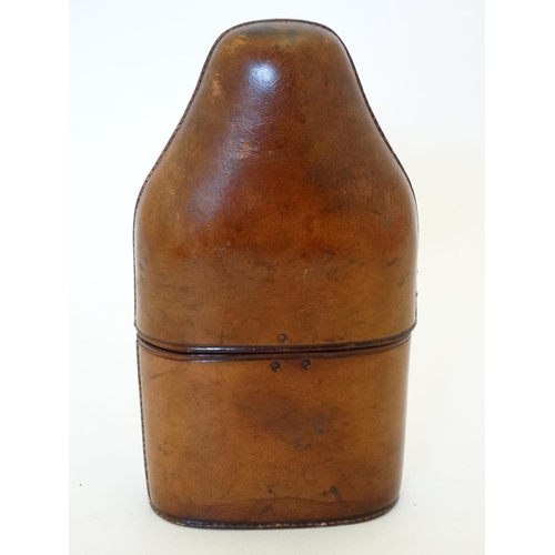 343 - Field Sports : An early 20thC glass flask with silver plate tot cup to top within a brown leather ca... 