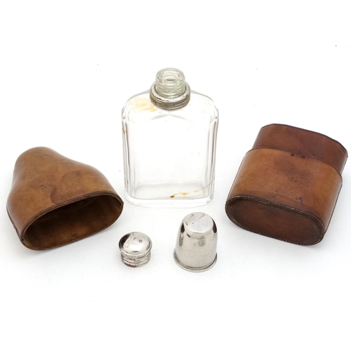 343 - Field Sports : An early 20thC glass flask with silver plate tot cup to top within a brown leather ca... 