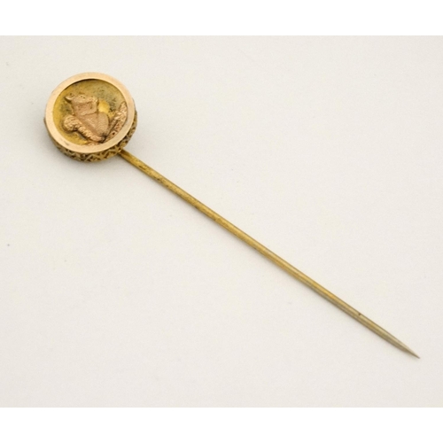 421 - A gilt metal stick pin surmounted by a circular image of a squirrel. The whole 3'' high