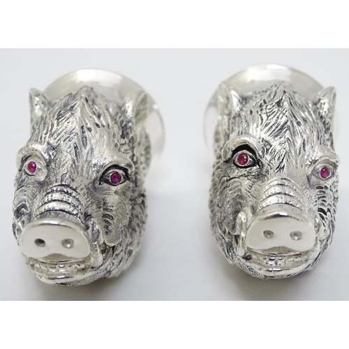 430 - A novelty white metal salt and pepper cruet formed as board heads with red stone eyes. marked .800. ... 