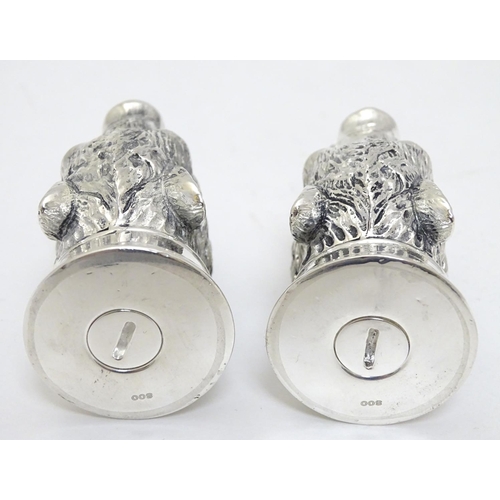 430 - A novelty white metal salt and pepper cruet formed as board heads with red stone eyes. marked .800. ... 