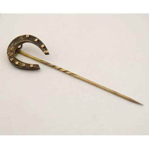 437 - A gilt metal stick pin surmounted by a horseshoe 3'' high