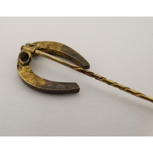 437 - A gilt metal stick pin surmounted by a horseshoe 3'' high