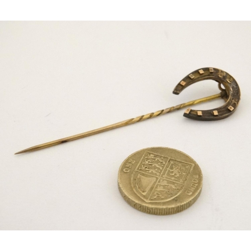 437 - A gilt metal stick pin surmounted by a horseshoe 3'' high