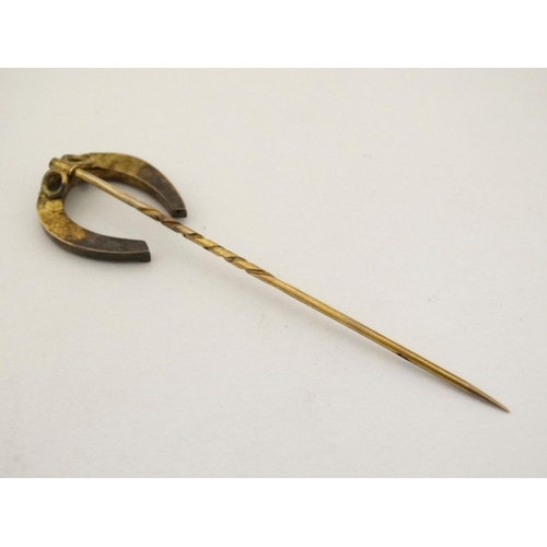 437 - A gilt metal stick pin surmounted by a horseshoe 3'' high