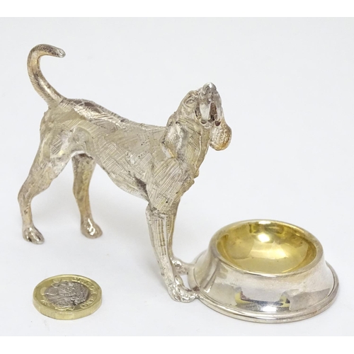 441 - A novelty silver plate table salt formed as a dog stood before a bowl. 21stC.  3 1/4'' high