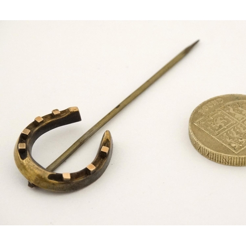 448 - A gilt metal stick pin surmounted by a horseshoe 2 3/4'' long