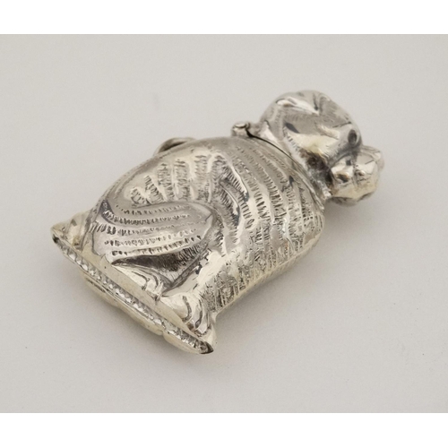 449 - A novelty silver vesta case formed as a seated dog with hinged head and striker under. Marked 'Sterl... 