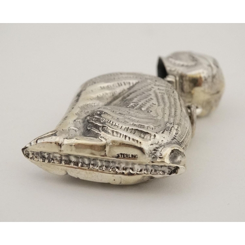 449 - A novelty silver vesta case formed as a seated dog with hinged head and striker under. Marked 'Sterl... 