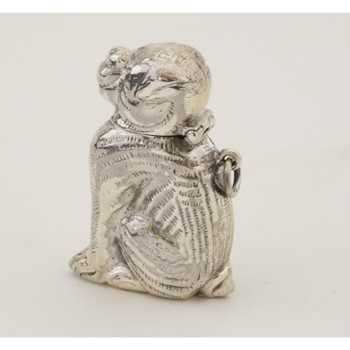 449 - A novelty silver vesta case formed as a seated dog with hinged head and striker under. Marked 'Sterl... 