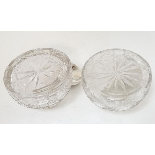 453 - Two cut glass inkwells having silver plated hinged tops with later applied cabochons depicting dogs ... 