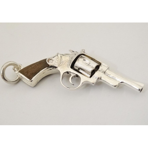 454 - A pendant formed as a hand gun / revolver. 21stC .  2 1/4'' long