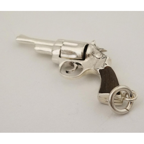 454 - A pendant formed as a hand gun / revolver. 21stC .  2 1/4'' long