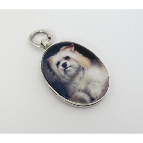 461 - A silver fob with later applied ceramic cabochon with dog decoration. Approx 1 1/2'' long