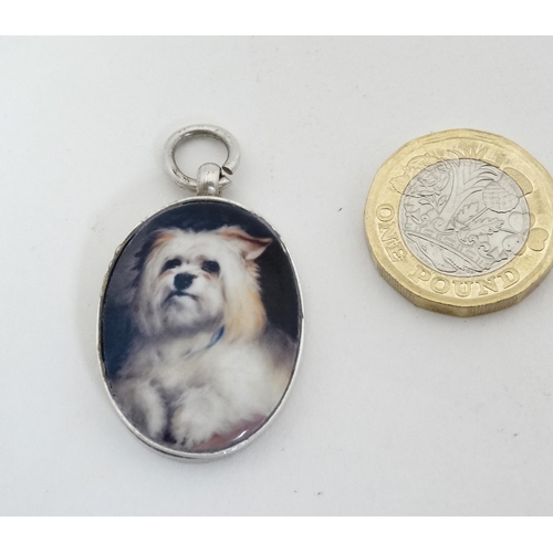 461 - A silver fob with later applied ceramic cabochon with dog decoration. Approx 1 1/2'' long