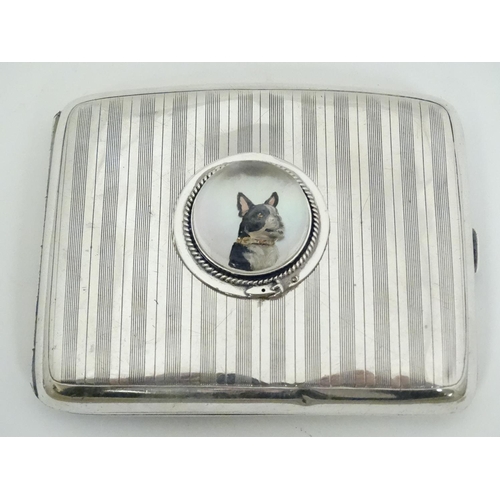 466 - A silver cigarette case hallmarked Birmingham 1921 with later applied Essex Crystal Cabochon depicti... 