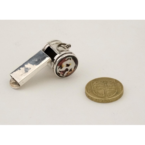 469 - Dog interest : A .925 silver whistle having two applied enamel dogs head cabochon. 21stC.  1 3/4'' l... 