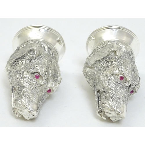 471 - A novelty white metal salt and pepper cruet formed as dog heads set with red stone eyes. marked .800... 