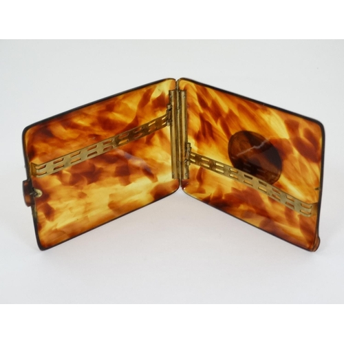 473 - A faux tortoiseshell cigarette case with later applied ceramic decoration depicting  dog head, 4 1/2... 