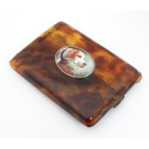 473 - A faux tortoiseshell cigarette case with later applied ceramic decoration depicting  dog head, 4 1/2... 