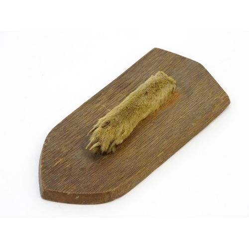 49 - Taxidermy: A mounted fox paw, affixed to a shield plinth, inscribed '9th Dec 1965', the shield 7 3/4... 