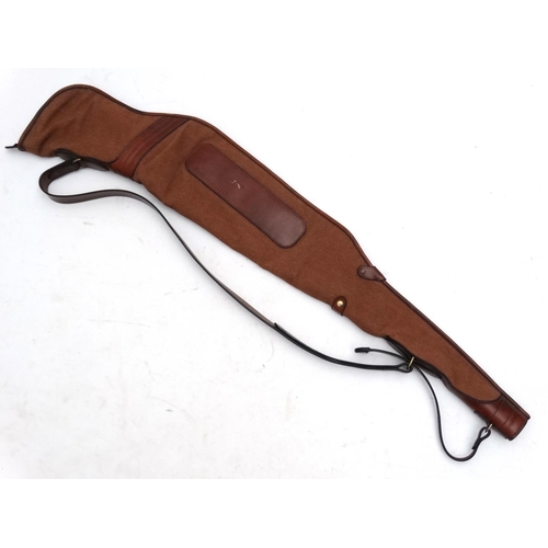 556 - Shooting: A heavy leather and canvas 'scoped rifle slip, of Spanish manufacture, the side panel stam... 