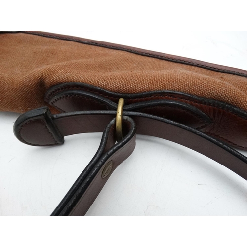 556 - Shooting: A heavy leather and canvas 'scoped rifle slip, of Spanish manufacture, the side panel stam... 