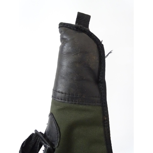 557 - Shooting : A 'scoped rifle slip , having green synthetic finish , 44'' long