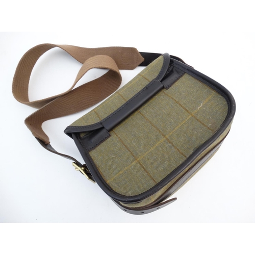 570 - Shooting: A Tweed and leather cartridge bag (100) by Croots, 'Helmsley' pattern, having suede interi... 