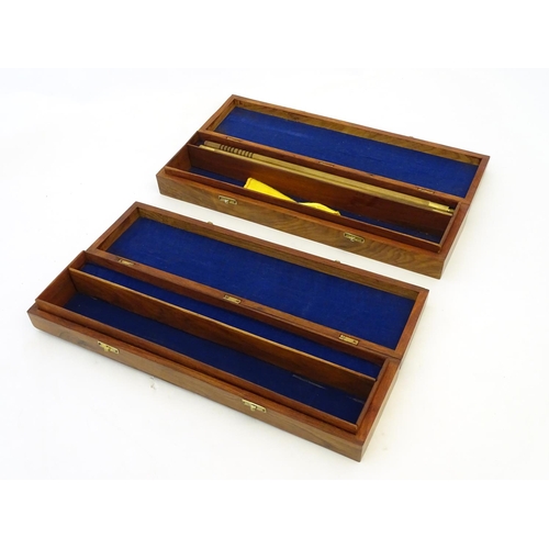 580 - Shooting: A matching pair of figured walnut cases for gun cleaning kit, each having two internal com... 