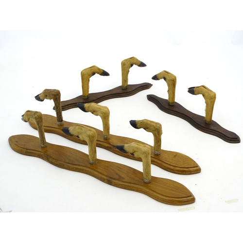 59 - Taxidermy: A continental mounted roe deer hoof gun rack for three guns, together with another for tw... 