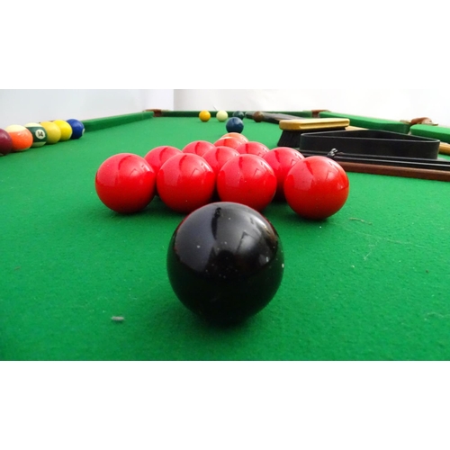 122 - A portable cue-sports table, with green baize top, together with six cues, a boxed set of snooker, p... 